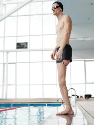 Photo Of Topless Man Standing On Poolside