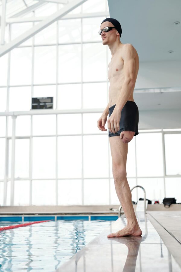 Photo Of Topless Man Standing On Poolside